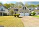 Charming home features a two-car garage, well-manicured lawn, and classic design at 75 Prestwick Ln, Peachtree City, GA 30269