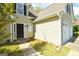 Inviting entrance with a dark front door and a walkway through the green yard at 75 Prestwick Ln, Peachtree City, GA 30269