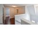 Upstairs hallway with hardwood floors and view into bedroom at 75 Prestwick Ln, Peachtree City, GA 30269