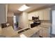 Kitchen featuring stainless steel appliances, granite countertops, and ample cabinet space at 75 Prestwick Ln, Peachtree City, GA 30269