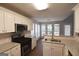 Well-equipped kitchen with stainless steel appliances and ample counter space at 75 Prestwick Ln, Peachtree City, GA 30269