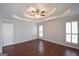 Bright main bedroom with two windows, wood floors, and neutral paint at 75 Prestwick Ln, Peachtree City, GA 30269
