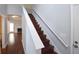 A wooden staircase featuring a white banister and a neutral colored wall at 75 Prestwick Ln, Peachtree City, GA 30269