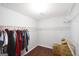Walk-in closet with wire shelving, dark wood floors, and stored cardboard boxes at 75 Prestwick Ln, Peachtree City, GA 30269
