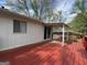 Wooden back deck with a partial overhang, and sliding door access to the home's interior at 1397 Iron Gate Blvd, Jonesboro, GA 30238