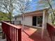 Exterior view of a wood back deck with railings, an overhang and door leading inside at 1397 Iron Gate Blvd, Jonesboro, GA 30238