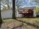 View of backyard featuring the wood back deck, stairs, and detached garage at 1397 Iron Gate Blvd, Jonesboro, GA 30238