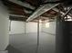 Unfinished basement with white painted walls, gray concrete floor, and exposed ductwork at 1397 Iron Gate Blvd, Jonesboro, GA 30238