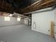 Unfinished basement featuring painted walls and floor with visible utilities at 1397 Iron Gate Blvd, Jonesboro, GA 30238