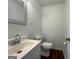 Half bathroom with wood flooring, framed mirror, and single sink vanity at 1397 Iron Gate Blvd, Jonesboro, GA 30238