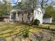 Angle view of a brick home featuring light blue shutters and a well-kept green lawn at 1397 Iron Gate Blvd, Jonesboro, GA 30238