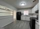 Kitchen features white cabinets, gray counter tops, and mosaic backsplash at 1397 Iron Gate Blvd, Jonesboro, GA 30238