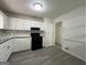 Kitchen features white cabinets, gray counter tops, and mosaic backsplash at 1397 Iron Gate Blvd, Jonesboro, GA 30238