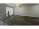 Bright living room featuring new hardwood flooring, white walls, and modern ceiling fan at 1397 Iron Gate Blvd, Jonesboro, GA 30238