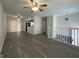 Open living room with ceiling fans, gray flooring, and view to second floor at 1397 Iron Gate Blvd, Jonesboro, GA 30238