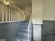 View of gray painted staircase leading to the upper level of the home at 1397 Iron Gate Blvd, Jonesboro, GA 30238
