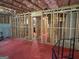 Unfinished basement featuring red flooring, exposed beams, and natural light at 1461 Judson Way, Riverdale, GA 30296