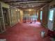 Unfinished basement featuring red flooring, exposed beams, and natural light at 1461 Judson Way, Riverdale, GA 30296