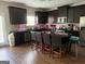 Modern kitchen with dark wood cabinets, stainless steel appliances, and a central island with seating at 1461 Judson Way, Riverdale, GA 30296
