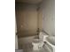 Compact bathroom featuring tile flooring, a standard tub/shower combination and clean white fixtures at 5575 Marbut Rd, Lithonia, GA 30058