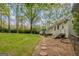 Expansive backyard featuring a stone walkway and a view of the house with a deck at 115 Bob White Trl, Fayetteville, GA 30215