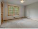 Cozy bedroom with neutral carpet, a window, and a ceiling fan at 115 Bob White Trl, Fayetteville, GA 30215