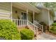 Inviting front porch with brick steps, white railings, and decorative plants in modern planters at 115 Bob White Trl, Fayetteville, GA 30215