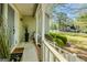 Welcoming front porch with decorative plants and a view of the landscaped front yard at 115 Bob White Trl, Fayetteville, GA 30215