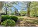 Spacious front yard with mature trees and lush landscaping providing shade and privacy at 115 Bob White Trl, Fayetteville, GA 30215