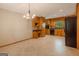 Spacious kitchen with tile flooring, cabinetry, black appliances, and natural light at 115 Bob White Trl, Fayetteville, GA 30215