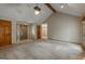 Inviting living room with neutral paint, plush carpet, and vaulted ceilings provides comfortable living space at 115 Bob White Trl, Fayetteville, GA 30215