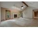 Vaulted living room features fireplace, carpet floors, and natural light from surrounding windows at 115 Bob White Trl, Fayetteville, GA 30215