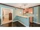 Finished basement bar with granite countertops, wood cabinets, wine rack and pendant lighting at 217 Brunswick Dr, Tyrone, GA 30290