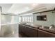 Finished basement featuring stained concrete floors, a TV and a large leather sectional at 217 Brunswick Dr, Tyrone, GA 30290