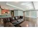 Finished basement with wet bar, leather couch, stained concrete floors, and trim at 217 Brunswick Dr, Tyrone, GA 30290