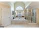Bright primary bathroom features a large tub, a separate shower, and a beautiful vanity area with large mirror at 217 Brunswick Dr, Tyrone, GA 30290