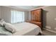 Cozy bedroom with neutral walls, large armoire, and natural light from the window at 217 Brunswick Dr, Tyrone, GA 30290