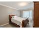 Bedroom with a wooden bed frame, neutral walls, and window at 217 Brunswick Dr, Tyrone, GA 30290
