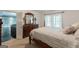 Bedroom with a wooden four-poster bed, dresser with lamps, and doorway to living area at 217 Brunswick Dr, Tyrone, GA 30290