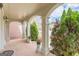 Inviting covered porch with classic brick flooring, elegant columns, and lush landscaping at 217 Brunswick Dr, Tyrone, GA 30290