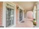 Lovely covered porch featuring brick flooring, windows, and sconce lighting at 217 Brunswick Dr, Tyrone, GA 30290