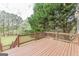 Second story deck with stained wood overlooking lush lawn and wooded scenery at 217 Brunswick Dr, Tyrone, GA 30290