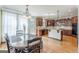View of the dining area featuring a wood table and chairs next to a kitchen with wood cabinets at 217 Brunswick Dr, Tyrone, GA 30290