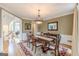 Formal dining room with a classic chandelier, hardwood floors, and wainscoting at 217 Brunswick Dr, Tyrone, GA 30290