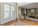 Welcoming entryway featuring double doors, hardwood floors, and a view into the cozy living room at 217 Brunswick Dr, Tyrone, GA 30290