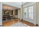 Elegant entryway with double doors opening to a formal dining room with a classic chandelier at 217 Brunswick Dr, Tyrone, GA 30290