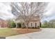 Brick home with manicured landscaping and sidewalks at 217 Brunswick Dr, Tyrone, GA 30290