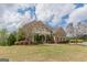 Beautiful brick home with a sprawling green lawn and mature landscaping on a sunny day at 217 Brunswick Dr, Tyrone, GA 30290