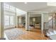 Bright foyer with hardwood floors and a view into the formal living room and staircase at 217 Brunswick Dr, Tyrone, GA 30290