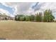 Expansive front lawn with mature trees, shrubs, and beautiful neighborhood homes at 217 Brunswick Dr, Tyrone, GA 30290